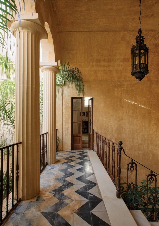 A sunlit colonnade with old floor tiles